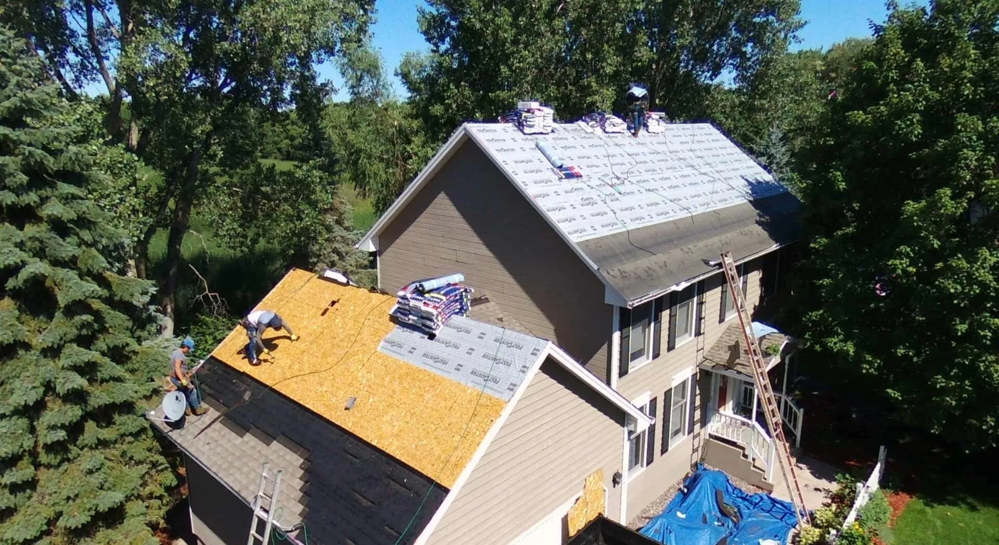 Professional roofing crew installing new residential roof